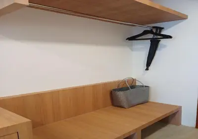 a room with a wooden shelf and a bench at La La Lay Beach House in Klong Muang Beach