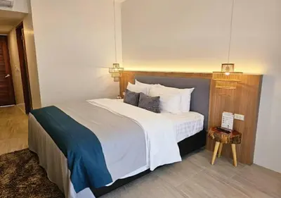 a bedroom with a large bed with white sheets and pillows at La La Lay Beach House in Klong Muang Beach
