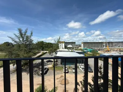 a balcony with a view of a parking lot at Новая студия Bellevue Bangtao in Laguna Phuket