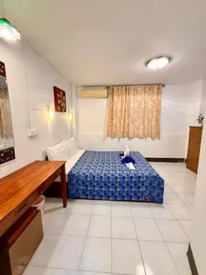 a small room with a blue bed in it at Om Sab House Patong in Patong Beach