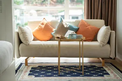a living room with a couch with pillows on it at 1 BR Suite 8-198 at Ozone Condo near Kata beach and surf in Kata Beach