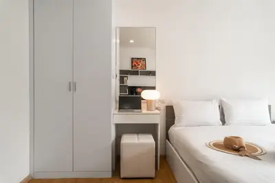 a bedroom with a bed and a desk with a hat on it at 1 BR Suite 8-198 at Ozone Condo near Kata beach and surf in Kata Beach