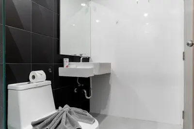 a bathroom with a sink and a toilet and a mirror at 1 BR Suite 8-198 at Ozone Condo near Kata beach and surf in Kata Beach