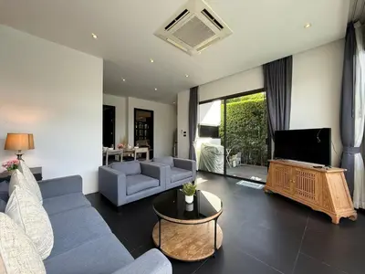 a living room with a couch and a table at 2 Bedroom Pool Villa Chalong in Chalong