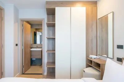 a bedroom with a door leading into a bathroom at Cosy 1 bedroom apt at Space Cherngtalay - 402 in Bang Tao Beach
