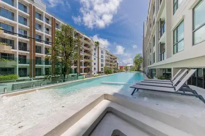 a swimming pool in the middle of a building at Brand new 1 BR apt 403 at Space Condo near Boat Avenue in Bang Tao Beach