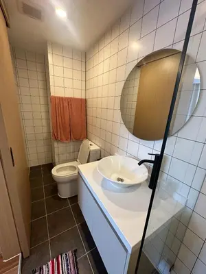 a bathroom with a sink and a toilet at FantaSea Kamala By Ere in Kamala Beach