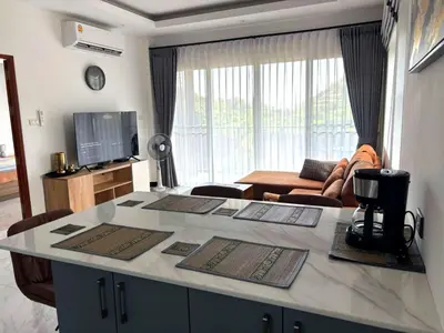 a kitchen and living room with a counter top at Relife apartments Большая квартира с панорамным видом на горы на Най Харне in Phuket Town