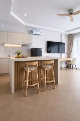 a kitchen with a counter and two bar stools at The Escape Kamala in Kamala Beach