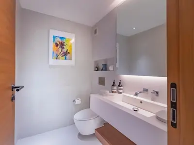 a white bathroom with a toilet and a sink at NEW Luxury 4BR Villa in Layan - Villa Zuma in Layan Beach