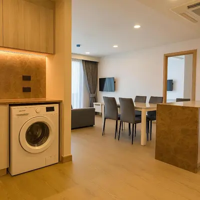 a living room with a washing machine and a table at The Ozone Condominium 2 bedroom by Search Estate in Phuket Town