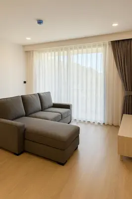 a living room with a couch and a large window at The Ozone Condominium 2 bedroom by Search Estate in Phuket Town