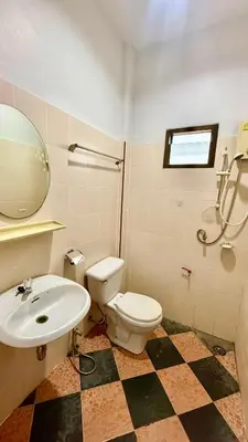a bathroom with a toilet and a sink at Cozy Bay Rawai in Phuket Town