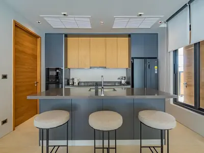 a kitchen with a large island with two stools at NEW Cozy 3BR Luxury Pool Villa - Villa Nova in Ban Pak Lak
