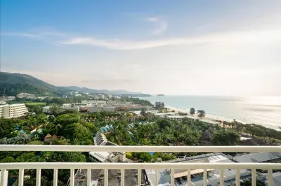 a view of the beach from the balcony of a resort at Waterfront 16D seaview 2 BR apartment - 5 min walk to Karon beach in Karon Beach