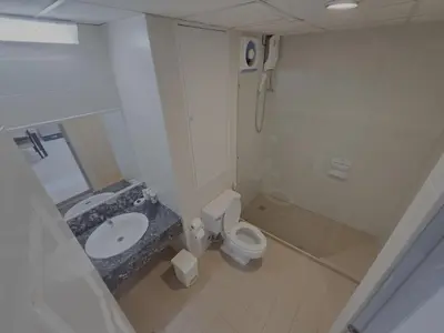 a bathroom with a toilet and a shower and a sink at WIVA by Woytuk in Patong Beach