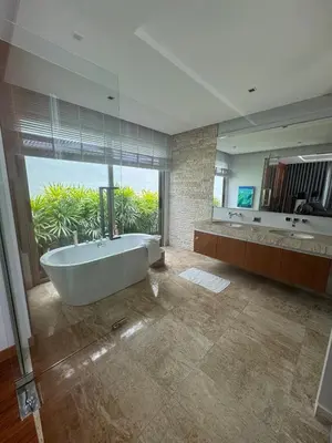 a large bathroom with a tub and a large window at Luxury Botanica Foresta 4 bed in Ban Phru Champa