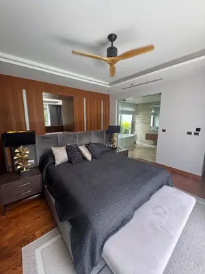 a bedroom with a large bed and a ceiling fan at Luxury Botanica Foresta 4 bed in Ban Phru Champa