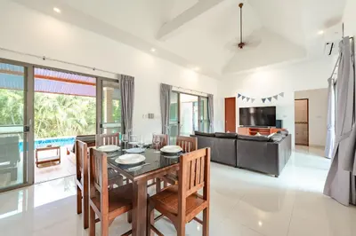 a dining room with a table and chairs at Orchid Pool Villa Rawai in Rawai Beach