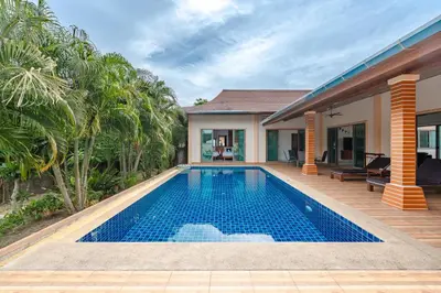 a swimming pool in the backyard of a house at Orchid Pool Villa Rawai in Rawai Beach