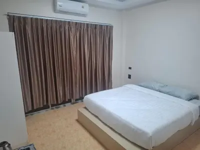 a bedroom with a bed and a large window at Kami Guest House Patong in Patong Beach