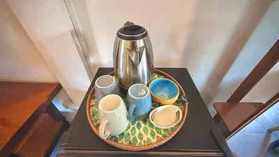 a tray with cups and a coffee pot on a table at The Simple Place - King and Twin in Klong Muang Beach