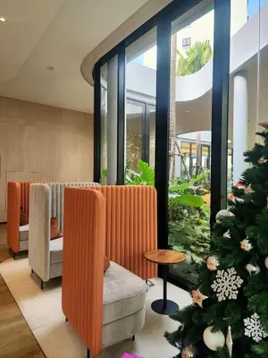 a christmas tree in the lobby of a salon at Cozy Palm Haven apartment in Kathu