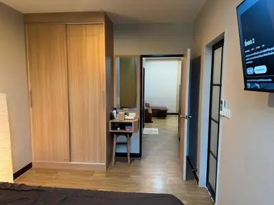 a hotel room with a bathroom and a television at Rare Find Penthouse with Private Office and Jungle Mountrain Views in Kamala Beach
