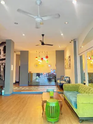 a living room with a green couch and a table at Acca Patong Residence in Patong Beach