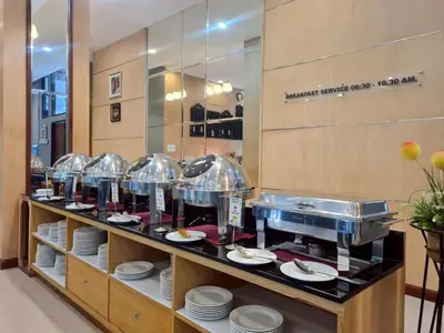 a buffet line with plates and dishes on display at The Par Phuket Hotel in Kathu