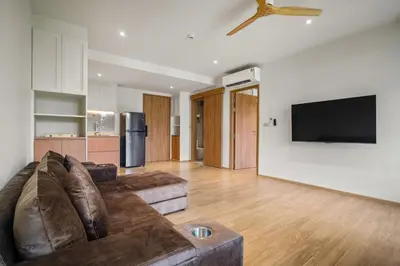 a living room with a couch and a flat screen tv at Laguna Beachside Block 2 by Banyan Living in Bang Tao Beach