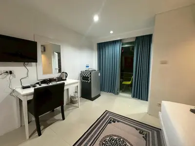 a bathroom with a desk and a sink in a room at Patong gray house in Patong Beach