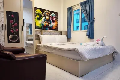 a bedroom with a bed with a stuffed animal on it at Cha Cha Guesthouse in Patong Beach