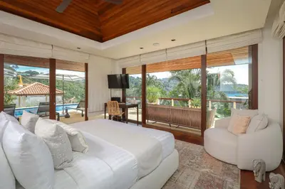 a bedroom with a large bed and a balcony at Katamanda Villa Allegra 5 bedroom Seaview villa in Ban Karon