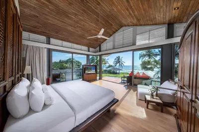 a bedroom with a large bed and a living room at Villa Malee Sai in Ban Han Pa To