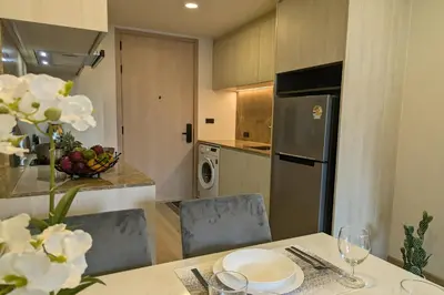 a kitchen with a table with a bowl of fruit at 1 Bedroom 108-114 Pool View at Ozone Laguna near Bangtao Beach and Golf in Bang Tao Beach