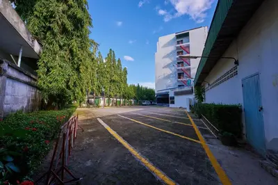 an empty parking lot next to a building at Nora Bukit Hotel in Ban Sam Kong