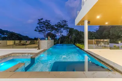 a swimming pool in the backyard of a house at V255 Huge Brand-New 7BR Pool Villa Rooftop View in Kata Beach