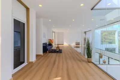 a hallway of a house with wood floors and glass walls at V255 Huge Brand-New 7BR Pool Villa Rooftop View in Kata Beach