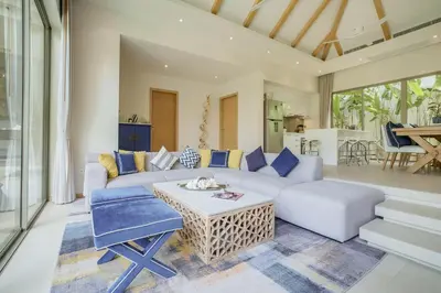 a living room with a couch and a table at Stylish 3BR Pool Villa trichada Airport Shuttle in Phuket Town