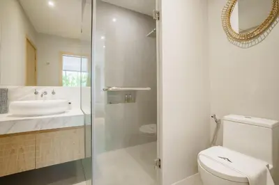 a bathroom with a toilet and a sink at Stylish 3BR Pool Villa trichada Airport Shuttle in Phuket Town