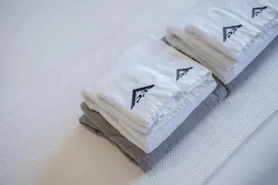 three towels sitting on top of a table at Stylish 3BR Pool Villa trichada Airport Shuttle in Phuket Town