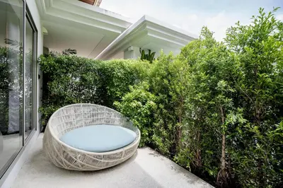 a wicker bath tub sitting outside of a house at Private 3BR Villa trichad Airport and Maid in Phuket Town