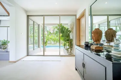 a kitchen with glass doors and a counter with plates at Private 3BR Villa trichad Airport and Maid in Phuket Town