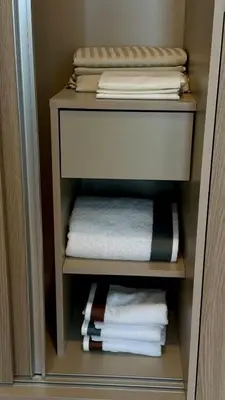 a closet with towels and folded towels in it at Cozy apartments for a comfortable stay and accommodation in Phuket Town