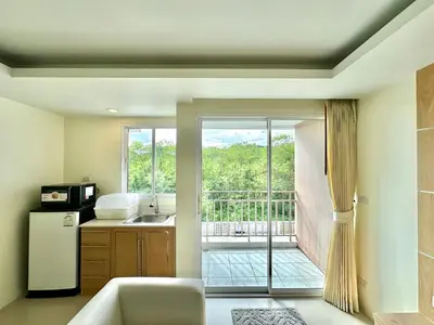 a kitchen with a sliding glass door to a balcony at Pingping&FamilyAonang-2 in Ban Khlong Son
