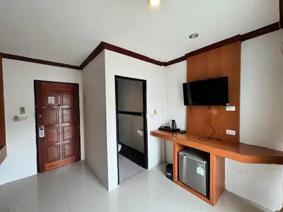 a living room with a television and a door at Soul House Patong in Patong Beach