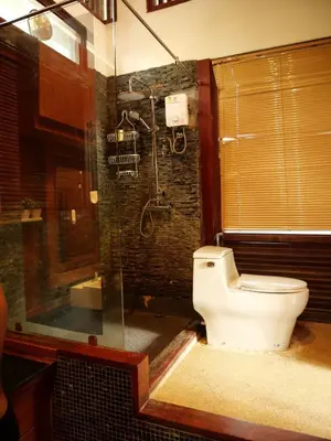 a bathroom with a toilet and a shower at Tropical Thai Loft with Koi Pond in Kamala Beach