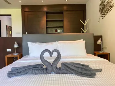 two swans making a heart on a bed at Villa Nature village kamala in Kamala Beach