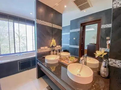 a bathroom with three sinks and a large mirror at Villa Nature village kamala in Kamala Beach